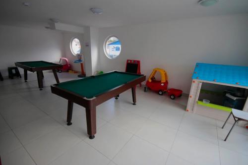 a room with two ping pong tables and toys at Sector Enjoy Premium Frente al Mar in Coquimbo