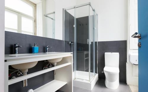 
a bathroom with a shower, toilet and sink at Best Guest Porto Hostel in Porto
