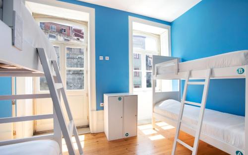 1 Schlafzimmer mit 2 Etagenbetten und einer blauen Wand in der Unterkunft Best Guest Porto Hostel in Porto