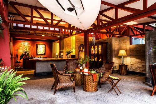a patio with chairs and a table and a bar at CASA CHU in Xochitepec