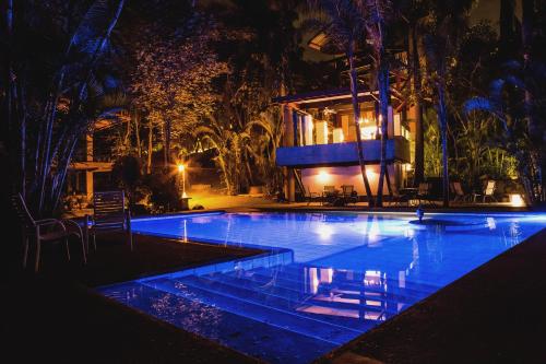 a swimming pool in front of a house at night at CASA CHU in Xochitepec