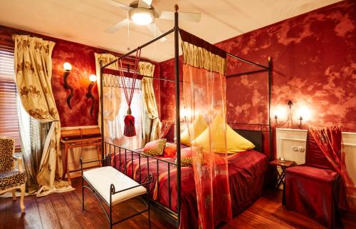 a bedroom with a canopy bed and a chair at Der Zauberlehrling in Stuttgart