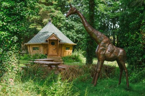 a statue of a giraffe standing in front of a house at Corffe House and Holiday Cottages in Barnstaple