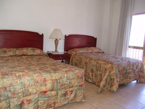 Una cama o camas en una habitación de Hotel Posada Arcos