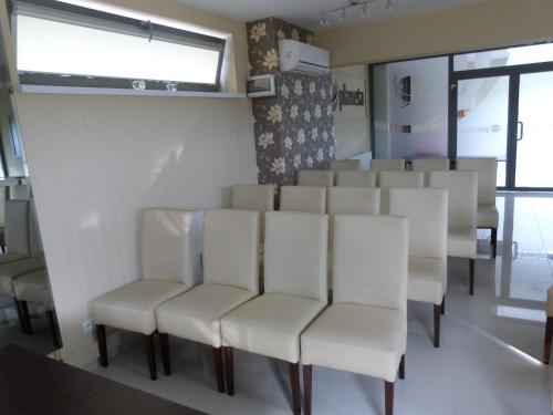 a row of white chairs in a room at QUEST HOTEL - dawniej Hotel Planeta in Brzesko