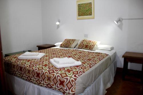 a bedroom with a bed with two towels on it at Hotel Vuelta del Ombu in Gobernador Ingeniero Valentín Virasoro