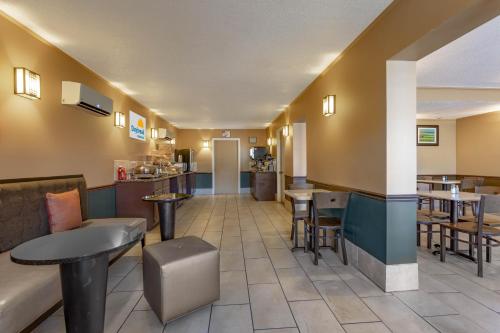 a lobby of a hotel with tables and chairs at Days Inn by Wyndham Breezewood in Breezewood