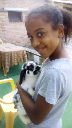 a young girl holding a black and white puppy at B&B Ma Maison in Govone
