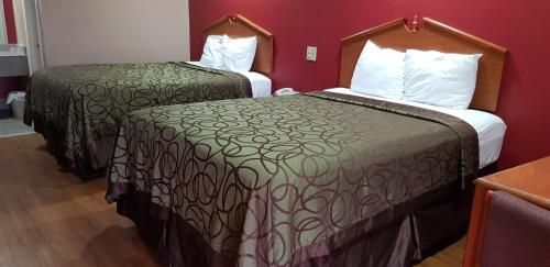 Katil atau katil-katil dalam bilik di Deluxe Inn
