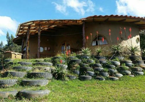 a house with a bunch of steps in front of it at Finca La Vispera in Samaipata