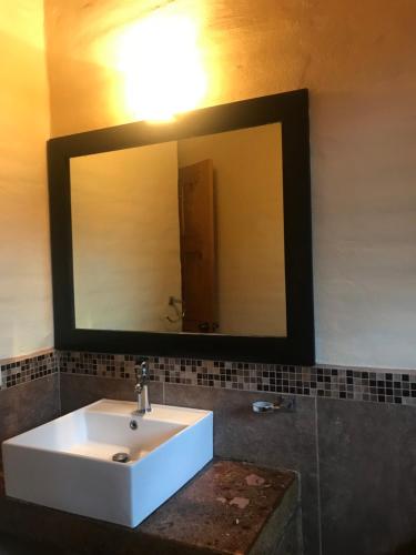 a bathroom with a white sink and a mirror at Caba&ntilde;a DNellys Maryana in Mazamitla