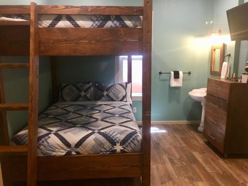 a bedroom with a bunk bed and a bathroom at The Groveland Hotel in Groveland