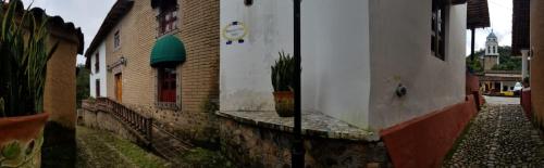 a group of buildings with a potted plant on a street at Hotel Mansion Real in San Sebastián del Oeste