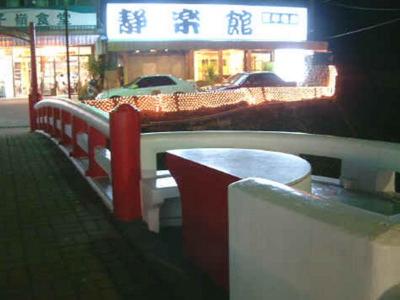 a row of benches on a city street at night at Jing Leh Resort Hotel in Baihe