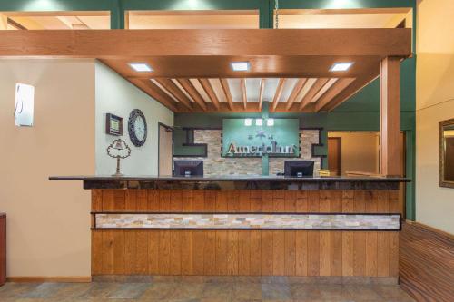 a lobby of a american inn with a waiting area at AmericInn by Wyndham West Bend in West Bend