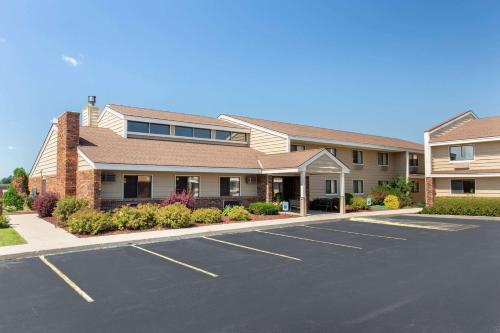 a parking lot in front of a building at AmericInn by Wyndham West Bend in West Bend