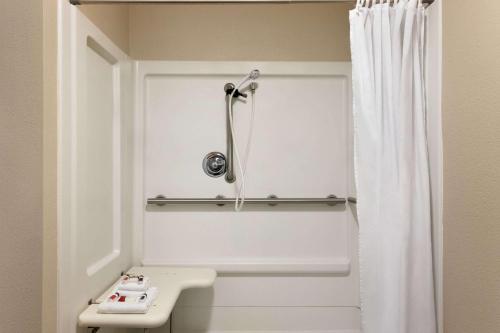 a bathroom with a shower curtain and a sink at Baymont by Wyndham Wellington in Wellington