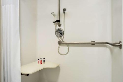 a bathroom with a shower curtain and a sink at Travelodge by Wyndham Bill WY Thunder Basin Ntl Grassland in Bill