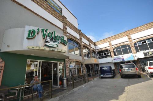 a building with a sign for a car dealership at Suites del Sol in Tijuana