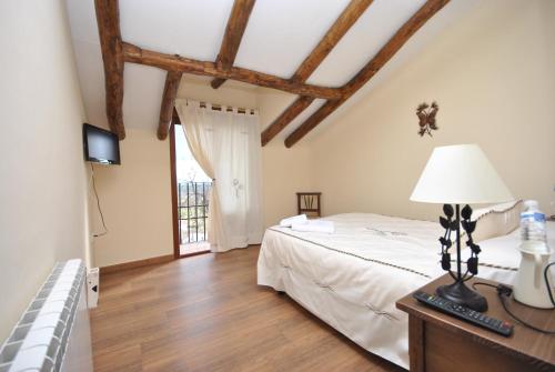 - une chambre avec un lit et une table avec une lampe dans l'établissement Los Garriolos, à Terrinches