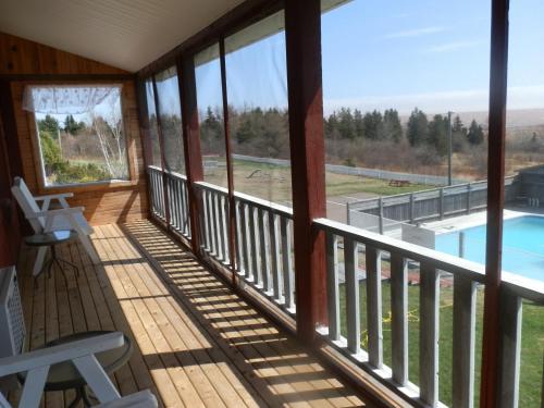 a screened in porch with a view of a swimming pool at Hopewell Rocks Motel & Country Inn in Hopewell Cape