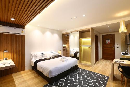 a hotel room with a bed and a bathroom at Montana Hotel Songkhla in Songkhla