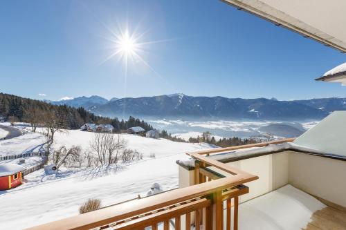 a balcony with a view of the snow covered mountains at Hotel Amaten in Brunico