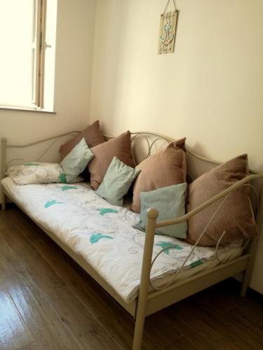 a couch with pillows on it in a room at Apartment Lunaja in Piran