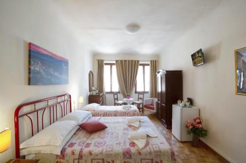 En eller flere senge i et værelse på Guesthouse Bel Duomo
