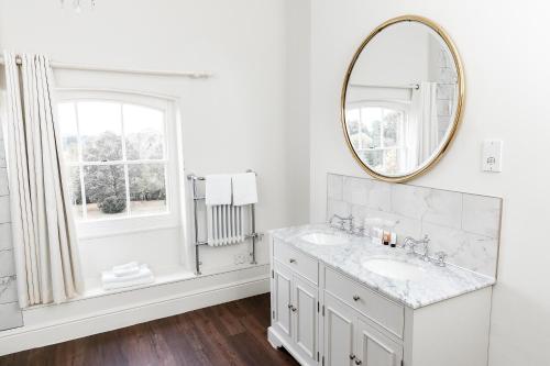 a white bathroom with a sink and a mirror at Winstanley House in Leicester