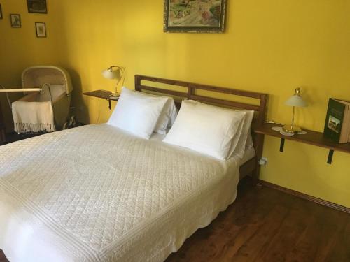 a bedroom with a bed with white sheets and pillows at Ubytovanie Meba in Prešov