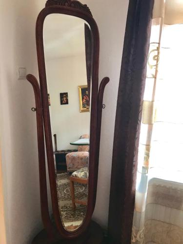 a mirror with a wooden frame in a room at Ubytovanie Meba in Prešov