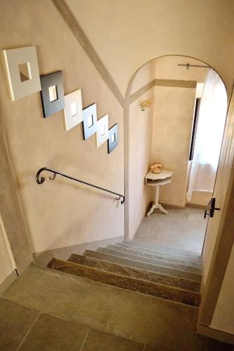 a hallway with stairs and a window and a table at - Il Casale Toscano - 1900mt from The Tower of Pisa - No Breakfast - Free Parking - No Tv - No Frigde - ONLY SELF CHECK IN FROM 3 PM in Pisa