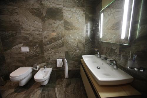 a bathroom with a sink and a toilet at Best Western Premier Ark Hotel in Tirana