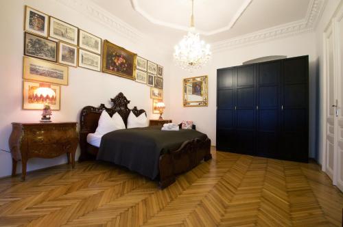 a bedroom with a bed and a chandelier at 7th HEAVEN Vienna Center Apartments in Vienna
