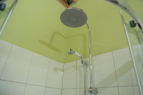 a shower with a shower head in a bathroom at Engiri Game Lodge and Campsite in Katunguru