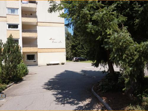 a parking lot in front of a building at FeWo mit Pool Haus Enere Au in Todtmoos