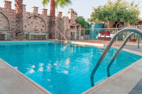 a swimming pool with blue water in front of a building at Luxury Villa Karteros in Karteros