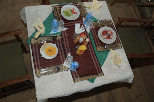 an overhead view of a table with plates of food at Engiri Game Lodge and Campsite in Katunguru