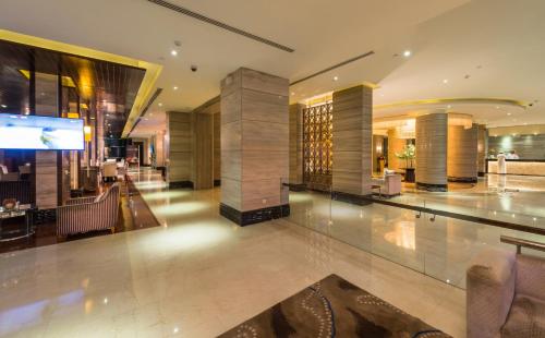 a lobby of a hotel with a fireplace at Boudl Al Qasr in Riyadh