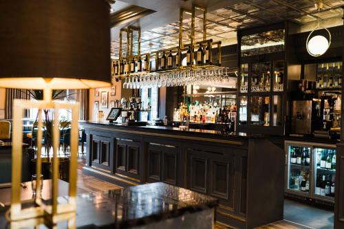 a bar with a counter with alcohol bottles at Da Vinci's Hotel in Derry Londonderry