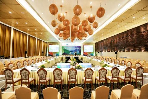 a large banquet hall with long tables and chairs at Palm Garden Beach Resort & Spa in Hoi An