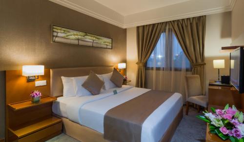 a hotel room with a bed and a television at Boudl Al Qasr in Riyadh