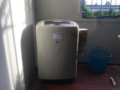 a heater in a room next to a window at Doze Hostel in Chiang Mai