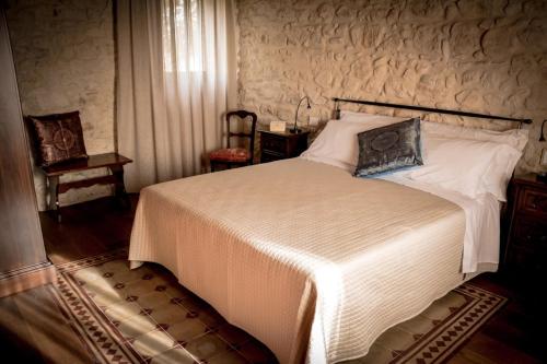 a bedroom with a large bed in a room at Agriturismo Valentina Cubi in Fumane