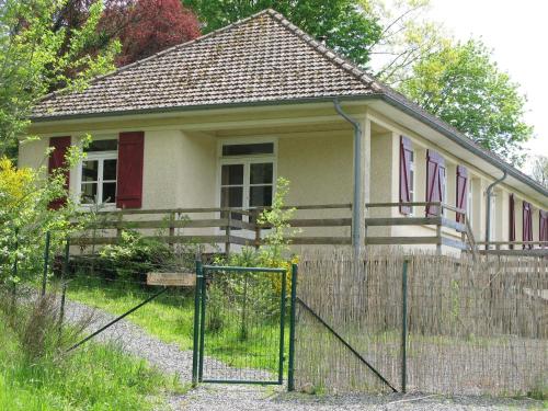 a small house with a fence in front of it at Spacious Holiday Home with Swimming Pool in Cuzy in Cuzy