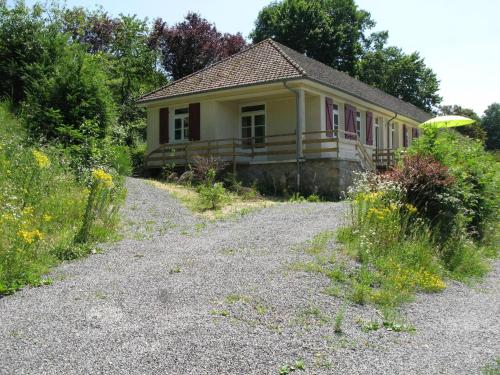 a small yellow house with a frisbee in front of it at Spacious Holiday Home with Swimming Pool in Cuzy in Cuzy