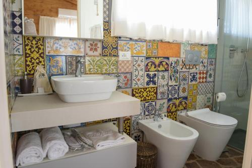 a bathroom with a sink and a toilet at Roccafiore Wine Resort & Spa in Todi