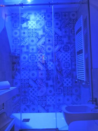 a bathroom with a glass shower with a toilet and a sink at Hotel San Luca in Verona