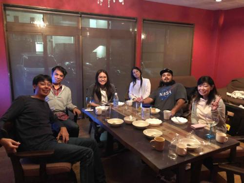 a group of people sitting around a table at HappyCloset&WasamonHostel in Kumamoto